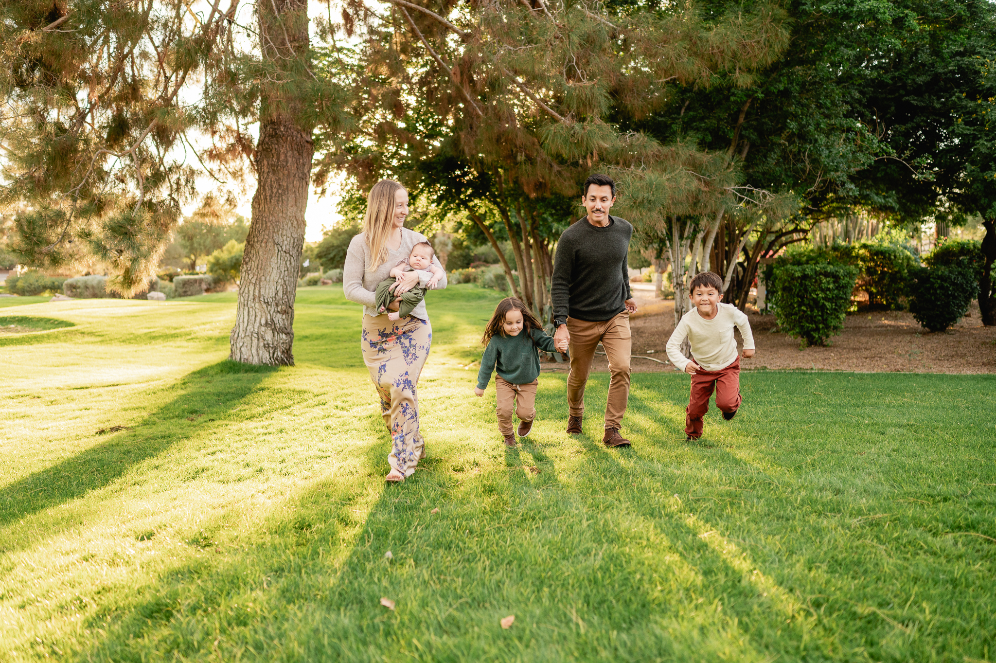 family of five walking along the grassy lawn at Camelback Inn - a photography location in Phoenix