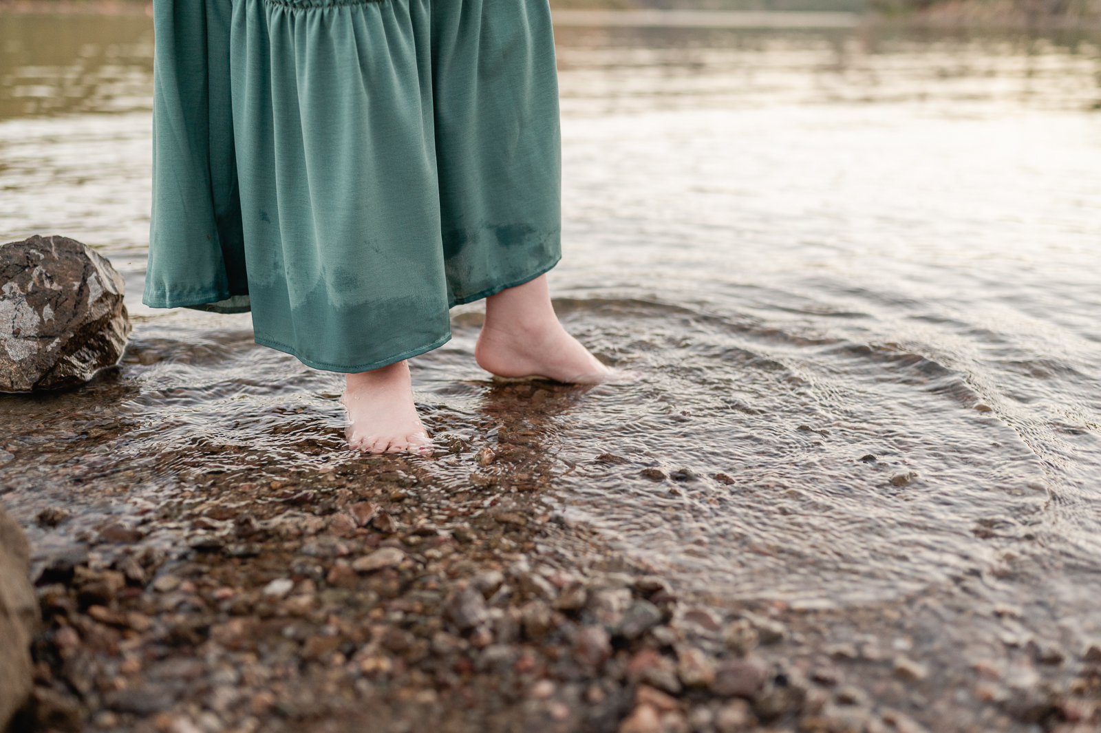 toes of a young girl in a teal dress playing in the lake at Butcher Jones