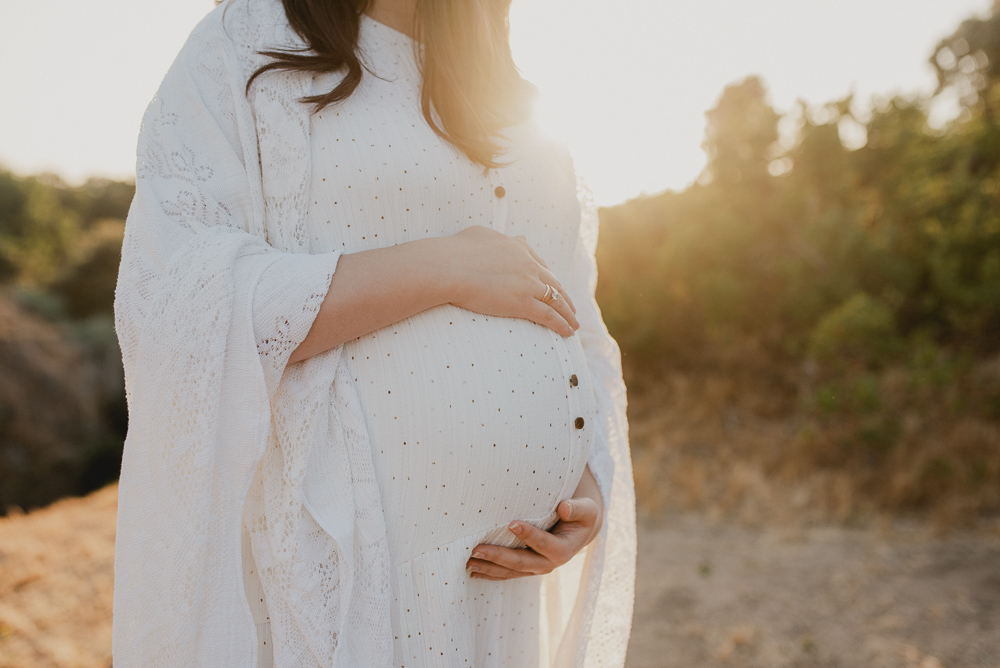 maternity photo session of mom holding her pregnant belly